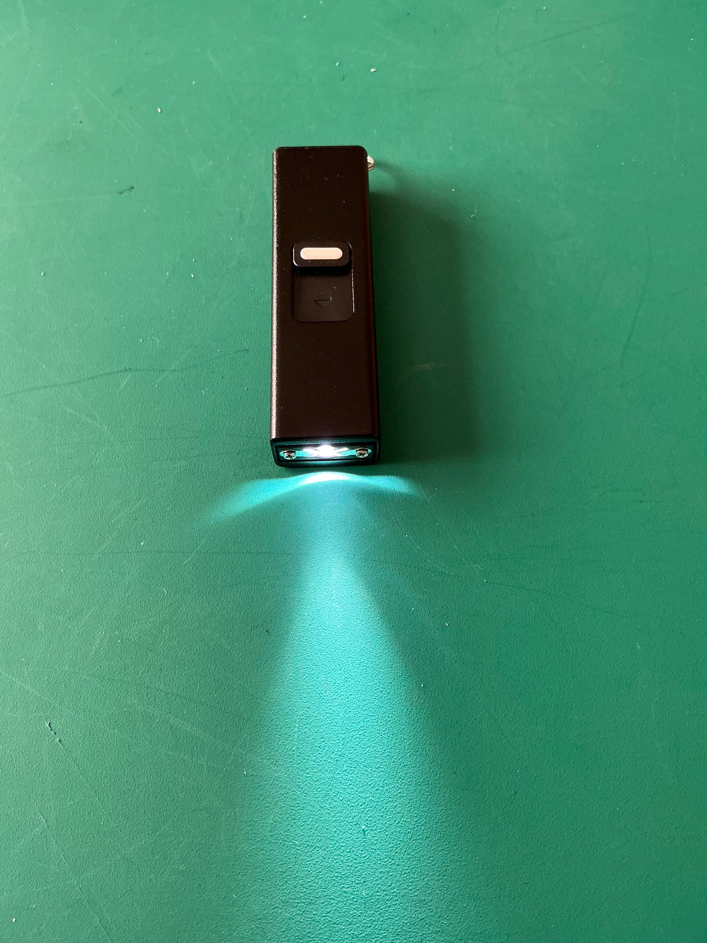 Miniature Self Defense Flashlight and an Electroshock device with a case.